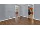 Open-concept living room with hardwood floors leading to the kitchen with ample natural light at 2675 Davidson Dr, Lithonia, GA 30058