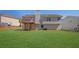 Spacious backyard featuring a well-manicured lawn, home, and deck at 3021 Hampton Club Way, Lithonia, GA 30038