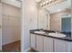 Bathroom featuring a double sink vanity, and tiled flooring adjacent to a walk in closet at 3021 Hampton Club Way, Lithonia, GA 30038