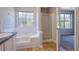Bathroom featuring a bathtub, and a glass door shower adjacent to a bedroom at 3021 Hampton Club Way, Lithonia, GA 30038