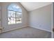 Bright bedroom featuring vaulted ceilings and a large arch window providing natural light at 3021 Hampton Club Way, Lithonia, GA 30038