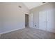 This bedroom features neutral walls, carpet flooring, and an easily accessible closet at 3021 Hampton Club Way, Lithonia, GA 30038