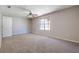 A bedroom with neutral walls, carpeted floor, and a bright window at 3021 Hampton Club Way, Lithonia, GA 30038