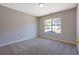 Carpeted bedroom with neutral walls and a bright window at 3021 Hampton Club Way, Lithonia, GA 30038