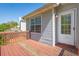 Home's outdoor deck features wood flooring and railing, perfect for entertaining at 3021 Hampton Club Way, Lithonia, GA 30038