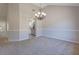 Open dining room with carpet, decorative chandelier, and views to kitchen at 3021 Hampton Club Way, Lithonia, GA 30038