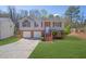 View of home with a well-maintained lawn, brick facade, and a two-car garage at 3021 Hampton Club Way, Lithonia, GA 30038