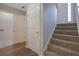 Hallway featuring carpeted stairs and a door to the laundry room with updated flooring at 3021 Hampton Club Way, Lithonia, GA 30038