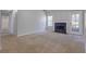 Bright living room with fireplace, neutral tones, and a view to hallway and door to back deck at 3021 Hampton Club Way, Lithonia, GA 30038