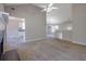 Open-concept living room with fireplace, vaulted ceilings, neutral paint, and carpet at 3021 Hampton Club Way, Lithonia, GA 30038