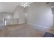 Spacious carpeted living room with high ceilings and view to staircase and upper level at 3021 Hampton Club Way, Lithonia, GA 30038