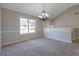Carpeted living room with decorative chandelier and natural light at 3021 Hampton Club Way, Lithonia, GA 30038