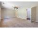 Spacious primary bedroom with a ceiling fan and access to an ensuite bathroom and closet at 3021 Hampton Club Way, Lithonia, GA 30038