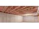 Unfinished basement featuring concrete walls, exposed ceiling, and pink insulation at 537 Pine Shadows Dr, Dallas, GA 30157