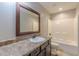 Bathroom with white ceramic sink, brown vanity, framed mirror, and white tub at 537 Pine Shadows Dr, Dallas, GA 30157