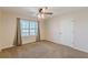 Bright bedroom with a ceiling fan, large window offering natural light and neutral walls and carpet at 537 Pine Shadows Dr, Dallas, GA 30157