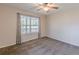 Bright bedroom with a ceiling fan and a bright window with backyard views and neutral carpet at 537 Pine Shadows Dr, Dallas, GA 30157