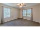 Relaxing bedroom featuring a large window, ceiling fan, and carpeted floors with neutral paint at 537 Pine Shadows Dr, Dallas, GA 30157