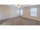 Spacious bedroom with neutral walls, carpet flooring, ceiling fan and two windows at 537 Pine Shadows Dr, Dallas, GA 30157