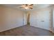 Inviting bedroom with ceiling fan and closet doors with a large window and door to another room at 537 Pine Shadows Dr, Dallas, GA 30157