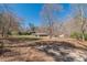 Ranch-style home surrounded by mature trees and foliage, set on a sprawling lot with a long driveway at 537 Pine Shadows Dr, Dallas, GA 30157