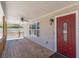 Charming front porch with a ceiling fan, and a window beside a red front door at 537 Pine Shadows Dr, Dallas, GA 30157