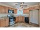 Corner view of the kitchen with modern appliances and wood cabinets at 537 Pine Shadows Dr, Dallas, GA 30157