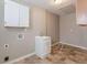 Dedicated laundry room with a utility sink and storage cabinets at 537 Pine Shadows Dr, Dallas, GA 30157