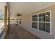 Long covered porch with wood floors and multiple windows at 537 Pine Shadows Dr, Dallas, GA 30157