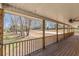 Spacious covered porch with wood floors and ceiling fan at 537 Pine Shadows Dr, Dallas, GA 30157