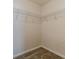 Compact walk-in closet with wire shelving and carpet flooring for organized storage at 537 Pine Shadows Dr, Dallas, GA 30157