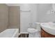 Bathroom featuring a tiled shower over tub, a white sink with vanity, and updated fixtures at 2261 Headland Ter, Atlanta, GA 30344