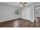 Bedroom with wood floors, neutral paint, a ceiling fan, and a large window at 2261 Headland Ter, Atlanta, GA 30344