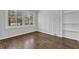 Bedroom with wood floors, wainscotting, built-in shelves, and natural light from a large window at 2261 Headland Ter, Atlanta, GA 30344