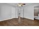 Bedroom with wood floors, neutral paint, a ceiling fan, and an en-suite bathroom at 2261 Headland Ter, Atlanta, GA 30344
