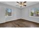 Bedroom with wood floors, neutral paint, a ceiling fan, and two windows at 2261 Headland Ter, Atlanta, GA 30344