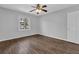 A standard bedroom is shown with hardwood floors, a ceiling fan, one window and a full-sized closet at 2261 Headland Ter, Atlanta, GA 30344