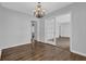 Dining room with hardwood floors, a modern chandelier and access to other rooms at 2261 Headland Ter, Atlanta, GA 30344