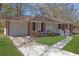 Charming brick ranch home with a well-maintained lawn and driveway leading to an attached garage at 2261 Headland Ter, Atlanta, GA 30344