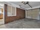 Spacious garage interior featuring brick walls, a window, concrete flooring, and garage door at 2261 Headland Ter, Atlanta, GA 30344