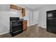 Kitchen with wood cabinets, black appliances, and access to multiple rooms at 2261 Headland Ter, Atlanta, GA 30344