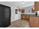 Functional kitchen featuring a black refrigerator, wood cabinets, and a window above the sink at 2261 Headland Ter, Atlanta, GA 30344