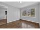 Room with light gray walls, hardwood floors, and a large window at 2261 Headland Ter, Atlanta, GA 30344