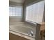 Large soaking tub with tile surround and windows offering natural light in this bathroom at 2295 Golden Valley Dr, Lawrenceville, GA 30043