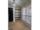 Bright dining area featuring a modern light fixture, built-in shelving and large window at 2295 Golden Valley Dr, Lawrenceville, GA 30043