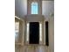 Bright foyer featuring a tall window, black front door, and light wood flooring at 2295 Golden Valley Dr, Lawrenceville, GA 30043