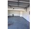 View of an empty garage with concrete flooring, white walls, and an overhead door at 2295 Golden Valley Dr, Lawrenceville, GA 30043