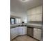 Corner view of kitchen featuring white cabinets, granite countertops, and stainless steel appliances at 2295 Golden Valley Dr, Lawrenceville, GA 30043