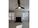 Living room with fireplace, large windows and a ceiling fan at 2295 Golden Valley Dr, Lawrenceville, GA 30043