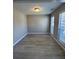 Empty living room with light wood flooring and natural light from the windows at 2295 Golden Valley Dr, Lawrenceville, GA 30043